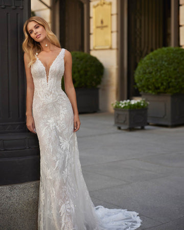 Sexy long mermaid wedding dress made in lace, beadwork and tulle. The V-neckline, illusion back and straps complete the look