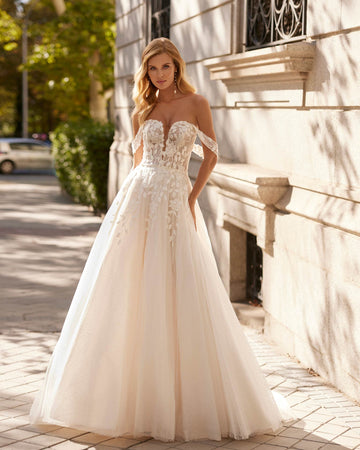 Long princess wedding dress crafted in snow tulle, lace and beadwork. Featuring a sweetheart neckline, closed back and straps