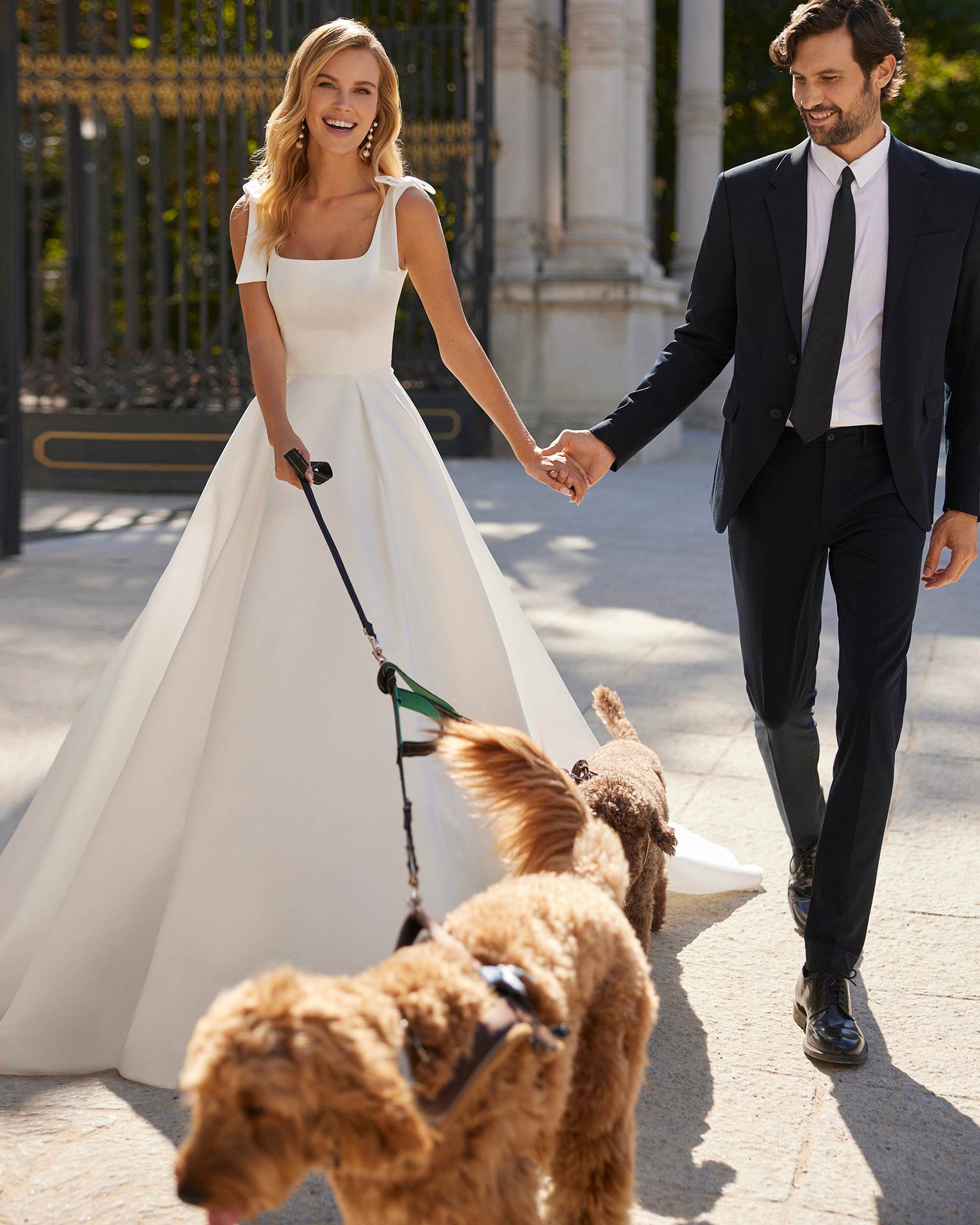 Classic long wedding dress crafted in satin. A square neckline, cut-out back and tie straps complete the look.