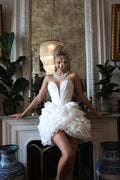 Short wedding dress with a V-neck and voluminous skirt. Main material: mikado, organza