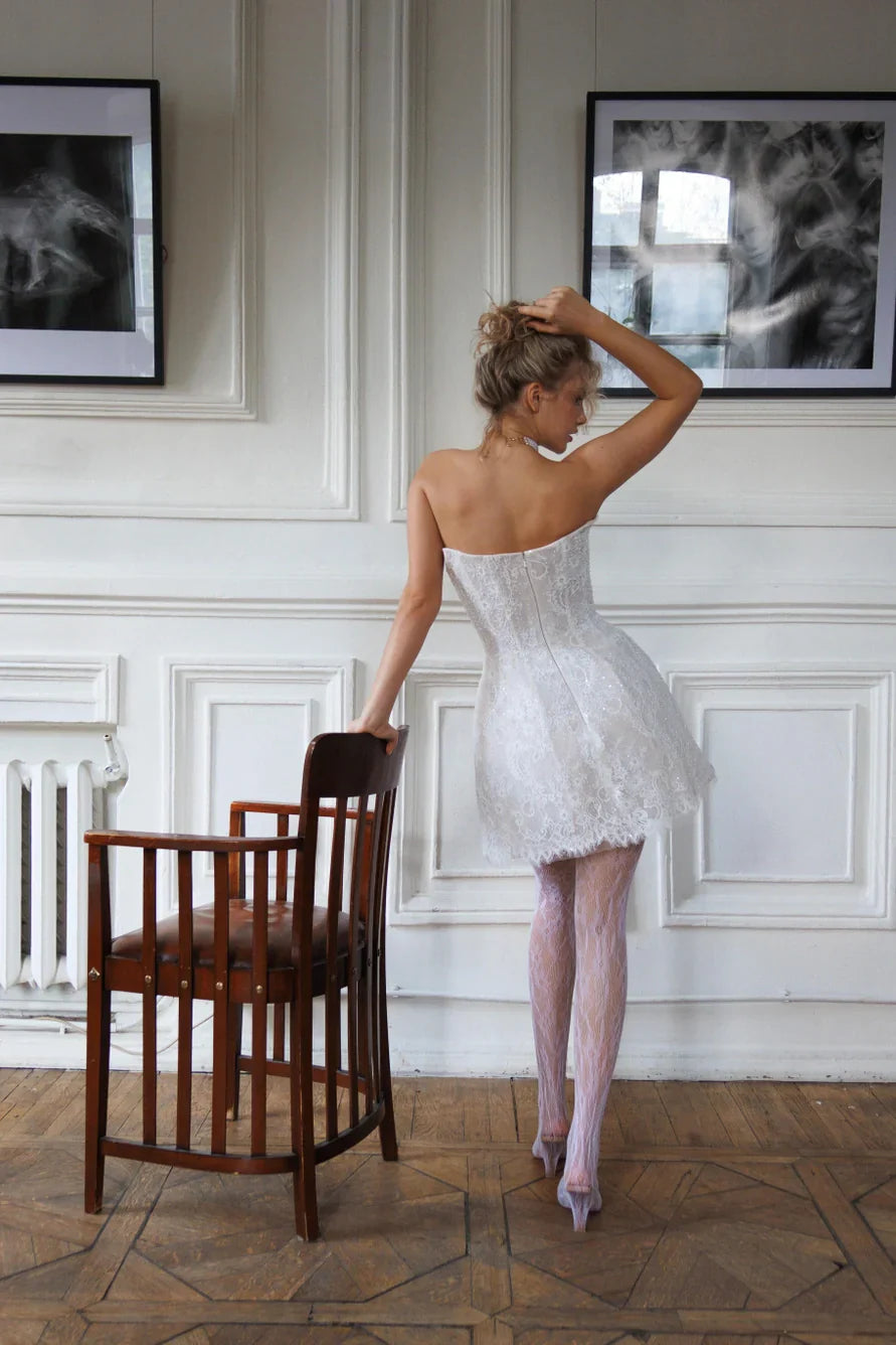 Short wedding dress with long detachable sleeves and a corset back and zipper. Main material: lace
