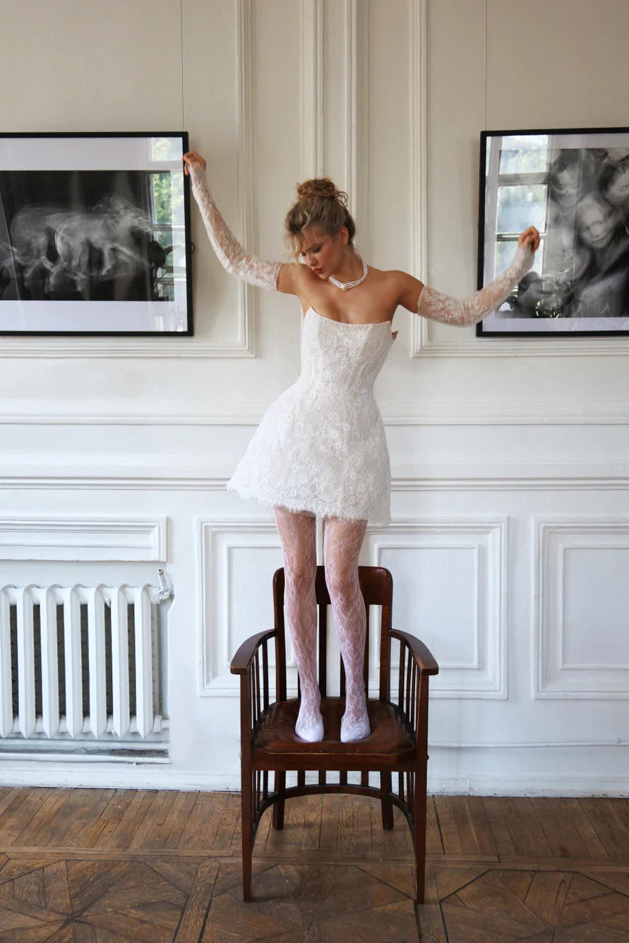 Short wedding dress with long detachable sleeves and a corset back and zipper. Main material: lace