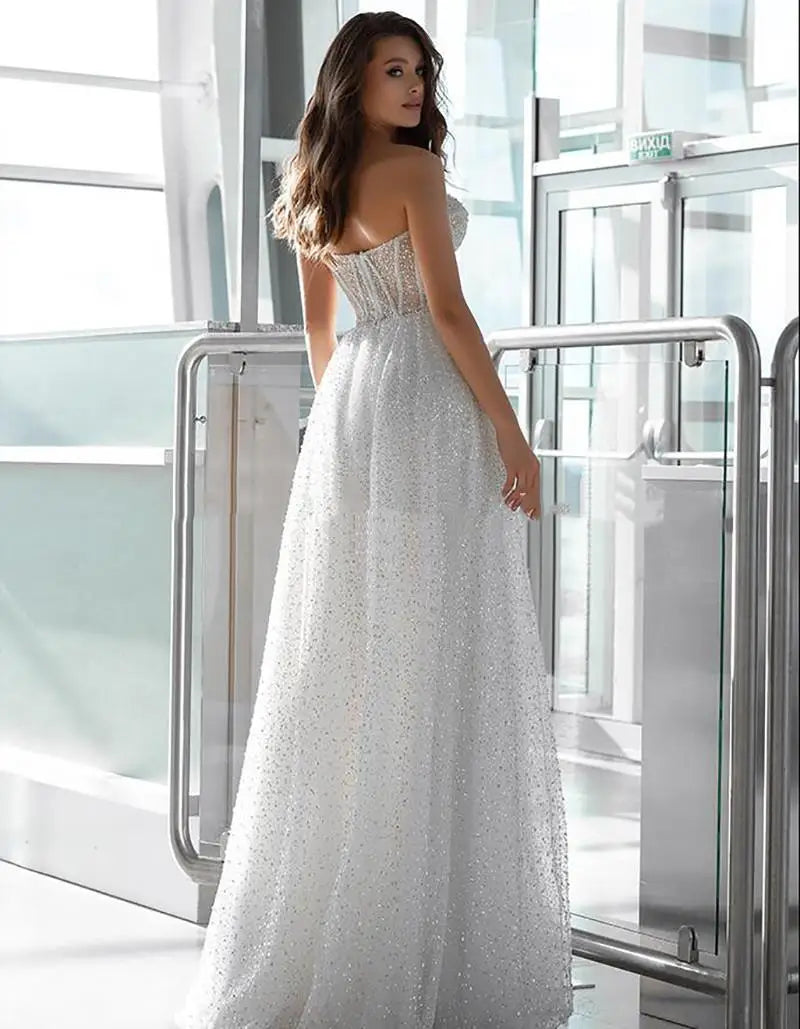 Corset sleeveless strapless glitter sweetheart tulle elegant A-line bridal gown back view