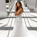 V-neck illusion lace applique tulle sexy sweep train backless bridal gown side view