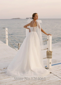 Spaghetti strap sequins pleated shiny A-line sweetheart bow court train bridal gown side view