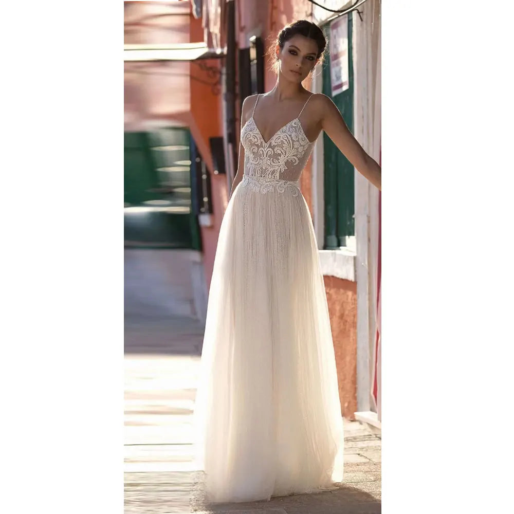 Spaghetti strap white yarn A-line lace illusion sweep train beach bridal gown side view