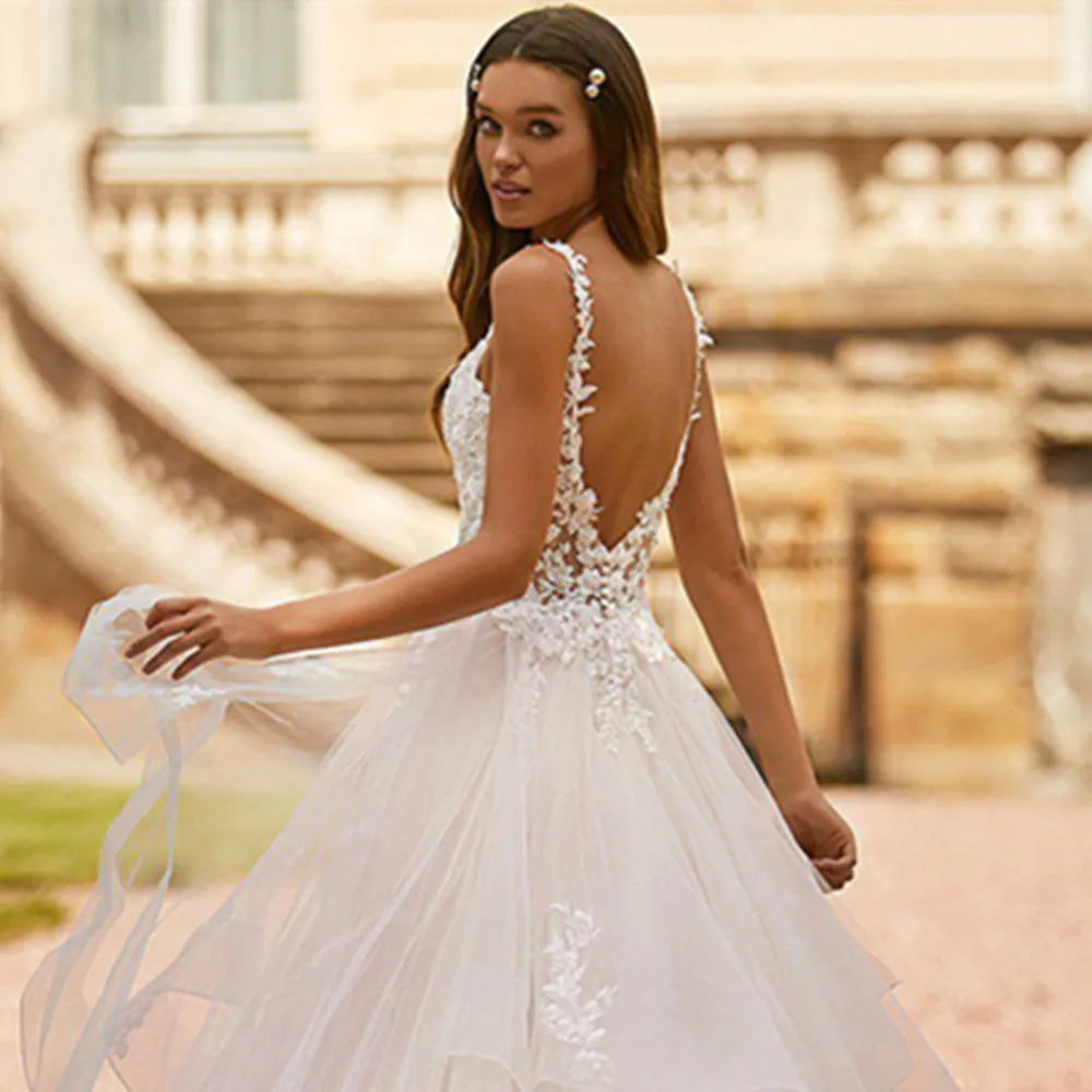 Court train lace ball gown V-neck spaghetti tiered zipper appliques wedding dress back view