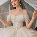 Lace-up crystal beading off-shoulder sparkly princess long train ball gown short sleeve wedding dress close-up