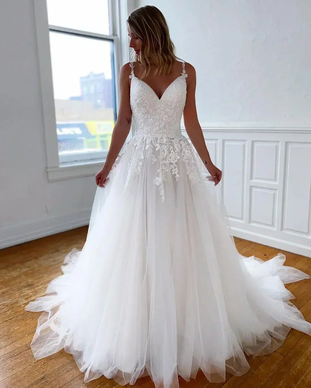 Classy elegance spaghetti straps backless A-line appliqued sweep train tulle bridal gown front view