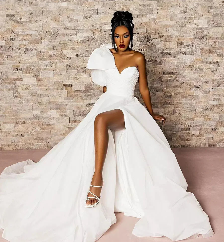 Single shoulder puff sleeve V-neck A-line beach side split big bow bridal dress front view