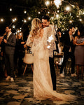 White bohemian flared sleeve mermaid lace V-back beach sexy bride gown close-up