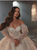 Romantic ball gown sequins pearls long sleeve shiny floor-length bridal gown front view