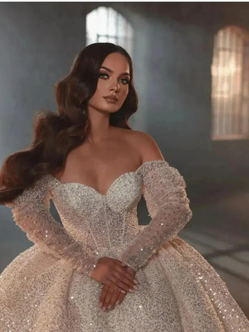 Romantic ball gown sequins pearls long sleeve shiny floor-length bridal gown front view