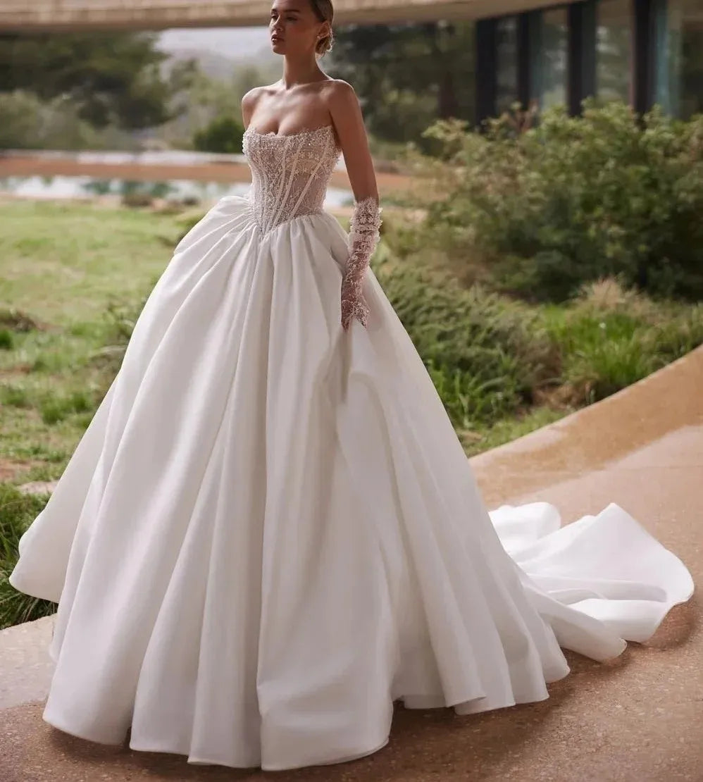 Luxurious A-line wedding dress 2026 strapless beaded pearls lace court train bridal gown