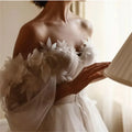 Princess A-line tulle off-shoulder floral floor-length sweep train bridal gown side view