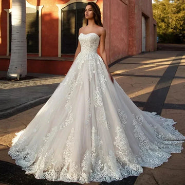 Elegant wedding dress 2026 strapless lace appliques tulle A-line sweep train bridal gown