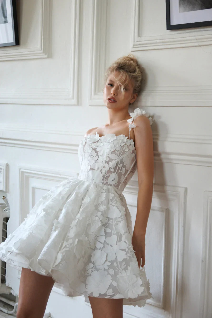 Short wedding dress with a full skirt and one strap. The back has a corset with lacing and a zipper. Main material: lace