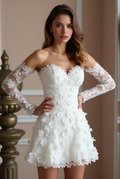 Elegant off-the-shoulder short wedding dress with 3D floral appliqués, sheer lace sleeves, and a sweetheart neckline – a perfect balance of romance and modern bridal fashion. | فستان زفاف قصير أنيق بأكتاف مكشوفة مزين بزهور ثلاثية الأبعاد وأكمام شفافة لمظهر عصري ورومانسي | Vestido de novia corto con escote corazón, encaje floral en 3D y mangas largas de encaje – ideal para bodas modernas y recepciones. | Robe de mariée courte en dentelle avec épaules dénudées et fleurs en 3D – parfaite pour une mariée modern