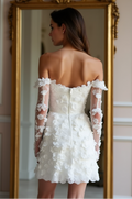 Chic short lace wedding dress with sheer embroidered floral sleeves, corset boning, and an exposed zipper closure – an effortlessly stylish bridal choice. | فستان زفاف قصير بظهر مكشوف وتطريز زهور ثلاثية الأبعاد لمظهر زفاف عصري ورقيق | Vestido de novia corto con espalda descubierta, cierre de cremallera y detalles en encaje floral – sofisticado y moderno. | Robe de mariée courte avec dos nu et détails en dentelle raffinés – idéale pour une mariée audacieuse et romantique.